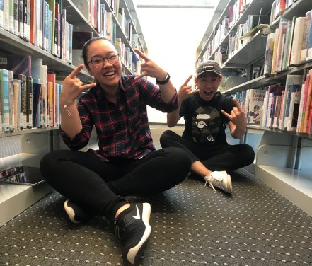 Smiling students pose for photo in library